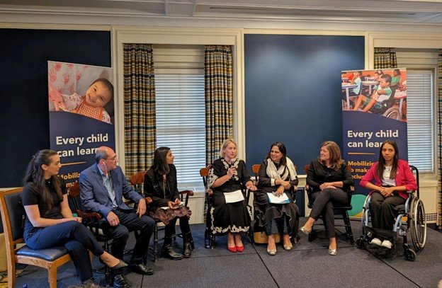 Photo of Kristen Molyneaux speaking at a panel event with members Perkins School for the Blind